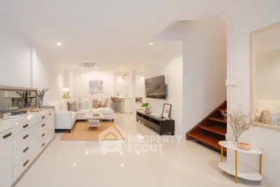 Spacious modern living room with elegant decor and open layout, perfect for relaxation and entertainment.
