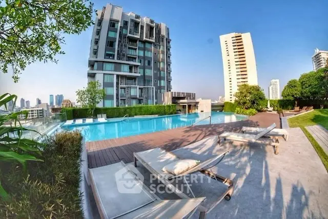 Luxurious rooftop pool with stunning city views in modern high-rise building.