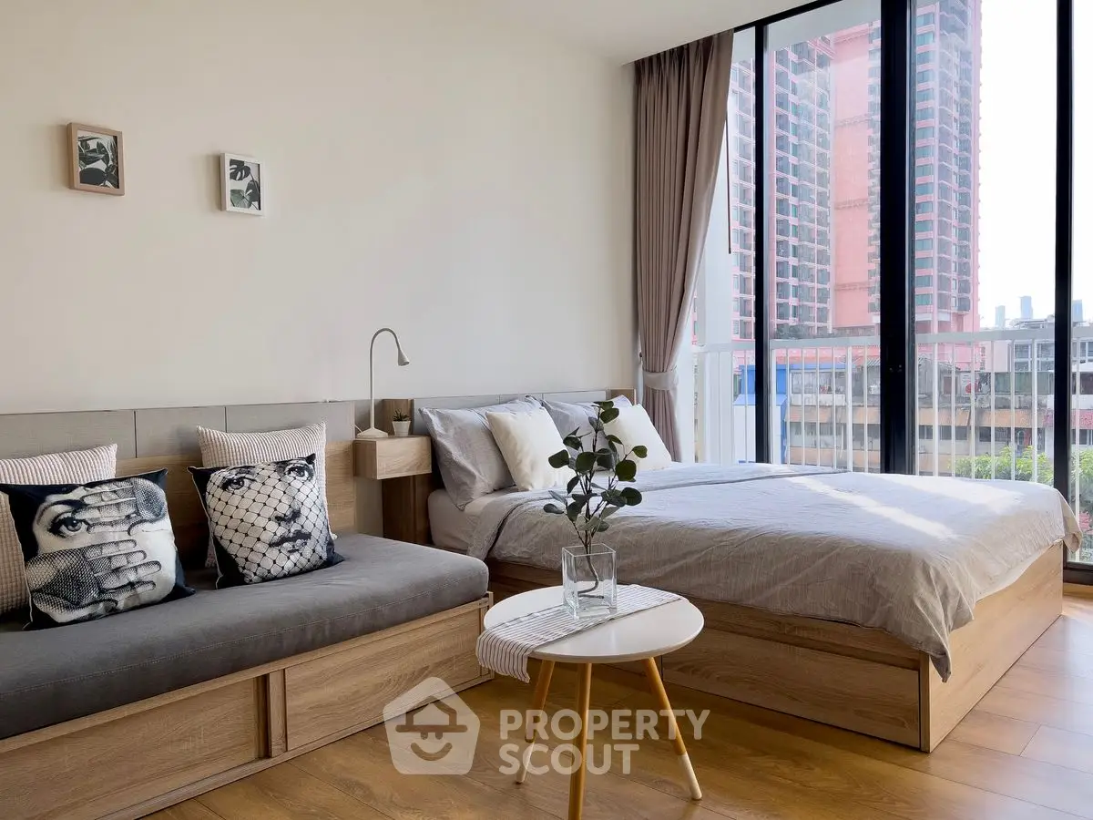 Modern bedroom with large windows and stylish decor in urban apartment