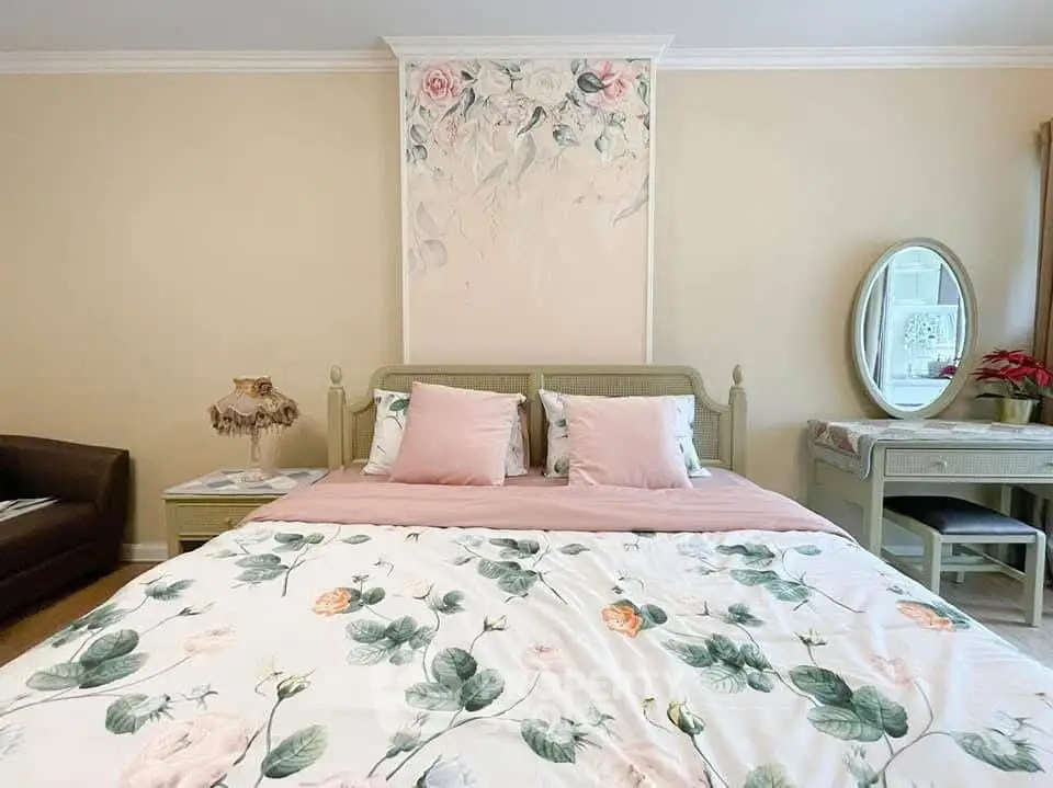 Charming bedroom with floral decor and elegant furnishings, perfect for a cozy retreat.