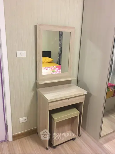 Modern bedroom with stylish vanity and mirror, featuring sleek wooden design and neutral tones.