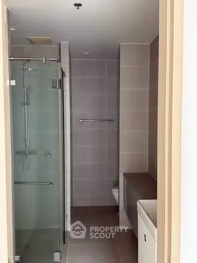 Modern bathroom with glass shower and sleek tile design
