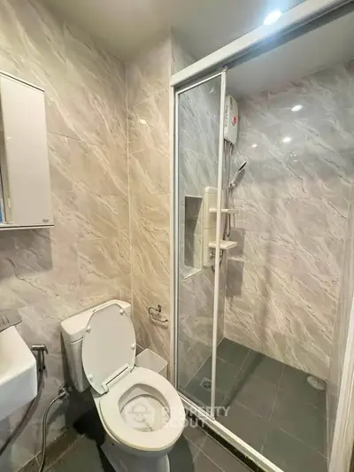 Modern bathroom with glass shower and sleek tile design