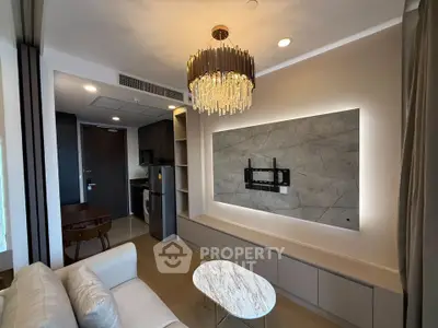 Modern living room with elegant chandelier and marble coffee table