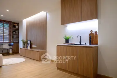Modern living room with sleek wooden cabinetry and stylish decor