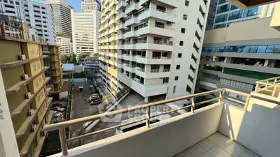 Urban balcony view with high-rise buildings and cityscape, perfect for city living enthusiasts.
