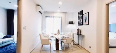 Modern dining area with elegant decor and natural light in a stylish apartment.