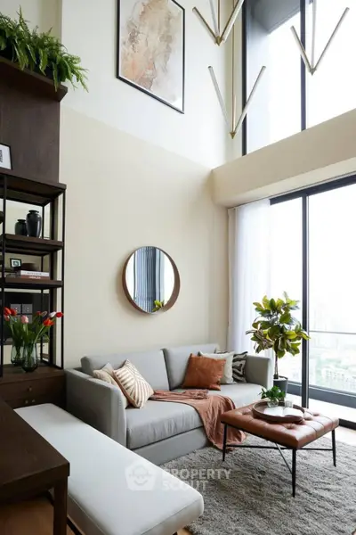 Modern living room with high ceilings, large windows, and stylish decor in a luxury apartment.