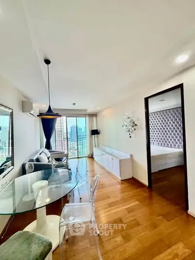 Modern living room with stylish decor and city view from balcony.