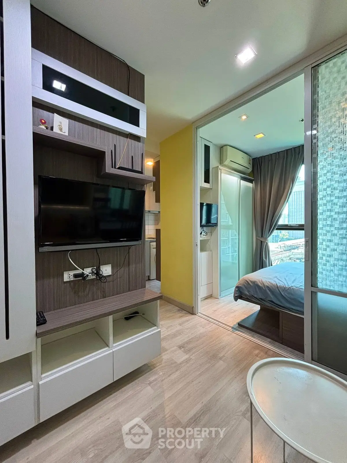 Modern apartment interior with stylish living room and cozy bedroom, featuring sleek design and natural light.