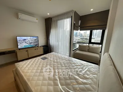 Modern bedroom with city view, featuring a cozy bed, wall-mounted TV, and large windows for natural light.