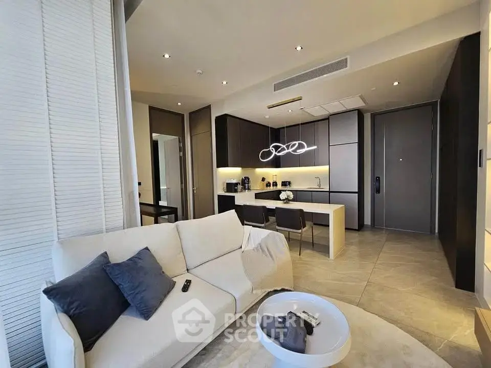 Modern open-layout living room with sleek kitchen and stylish decor