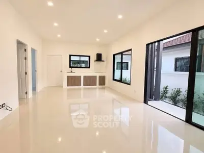 Spacious modern living room with large windows and sleek flooring