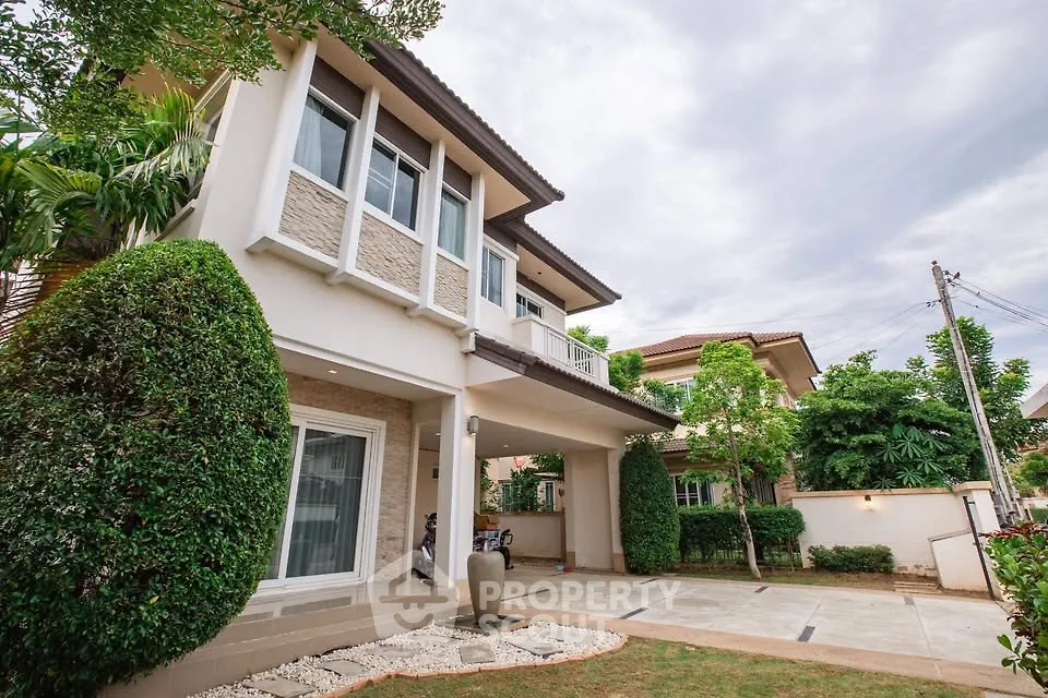 Stunning two-story house with landscaped garden and spacious driveway in a serene neighborhood.