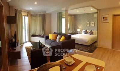 Spacious open-plan living room with modern decor and cozy bedroom view.