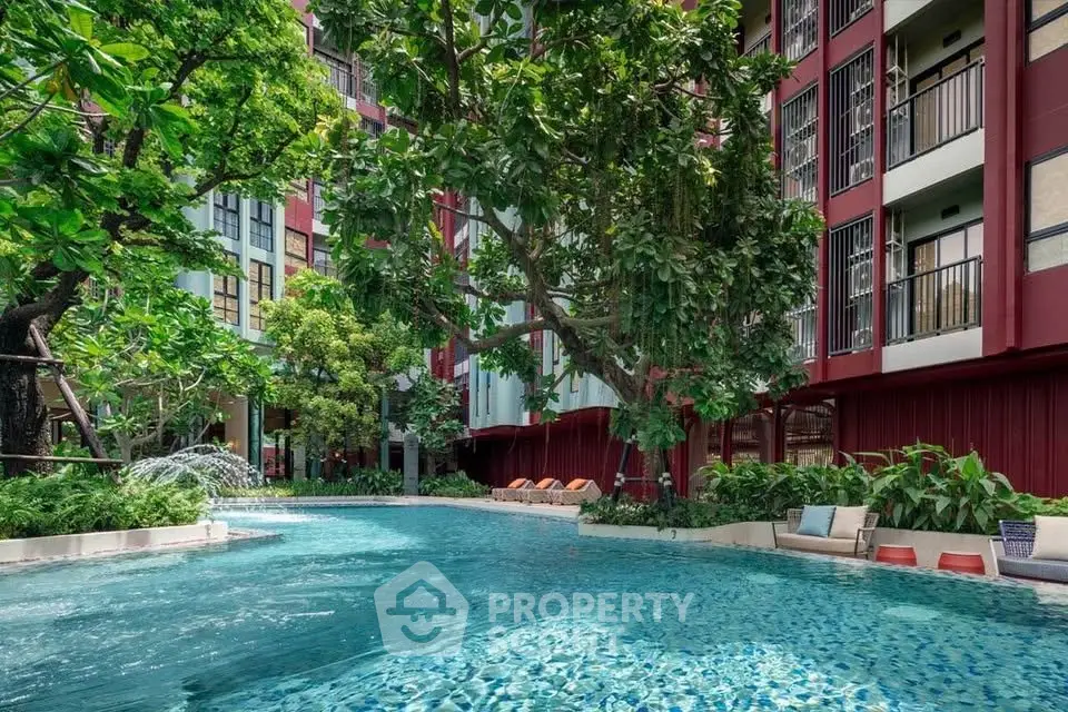 Luxurious apartment complex with stunning pool and lush greenery, perfect for relaxation and leisure.