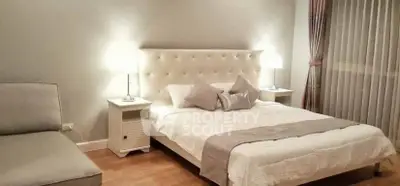 Elegant bedroom with plush headboard and cozy lighting