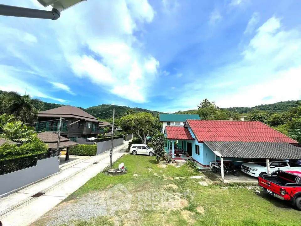 Charming suburban neighborhood with lush greenery and mountain views, featuring modern and traditional homes.