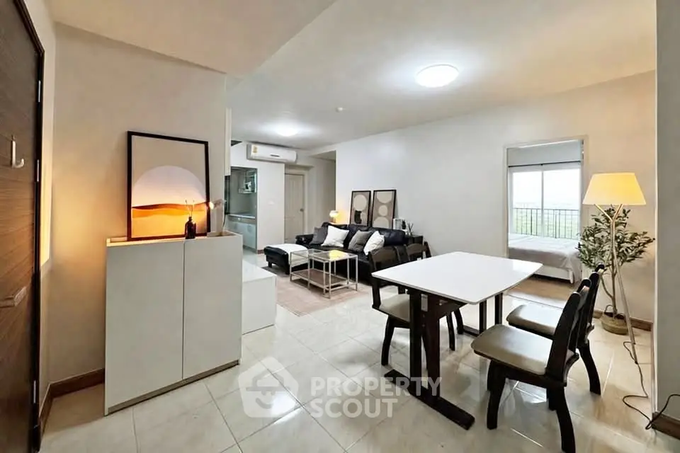 Spacious modern living room with dining area and natural light, perfect for comfortable living.