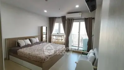 Spacious bedroom with balcony access in modern apartment