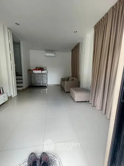 Spacious living room with modern decor and natural light