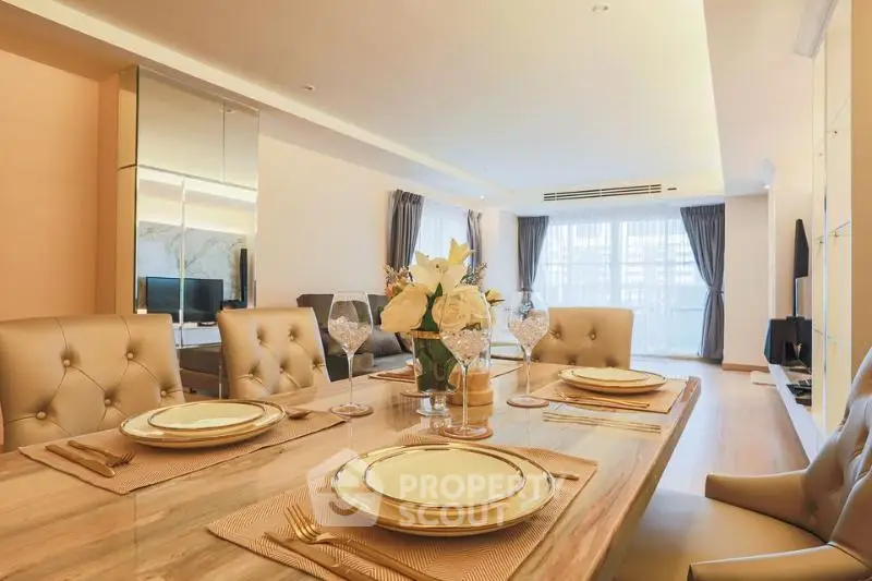 Luxurious open-plan living and dining area with elegant decor and natural light.