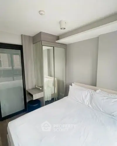 Modern bedroom with sleek design and mirrored wardrobe