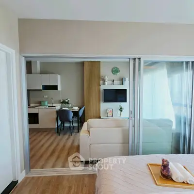 Modern open-plan living room with sleek kitchen and cozy dining area