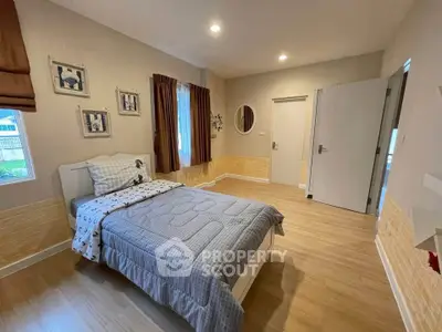 Cozy bedroom with stylish decor and natural light, perfect for relaxation.