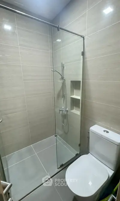 Modern bathroom with glass shower enclosure and sleek tile design