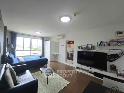 Spacious modern living room with large window and stylish decor