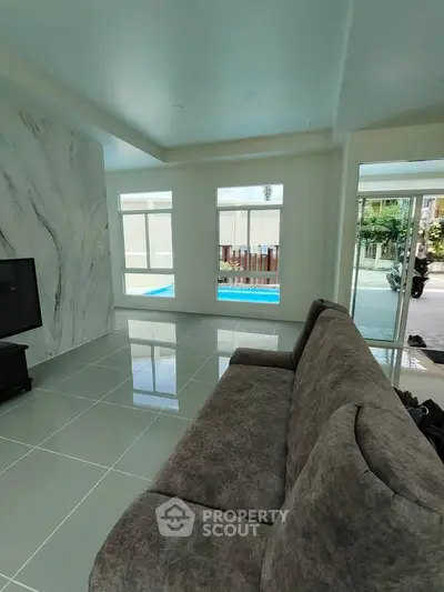 Spacious living room with pool view and modern decor