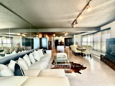 Spacious modern living room with open layout and stylish decor, featuring a large sectional sofa and dining area.