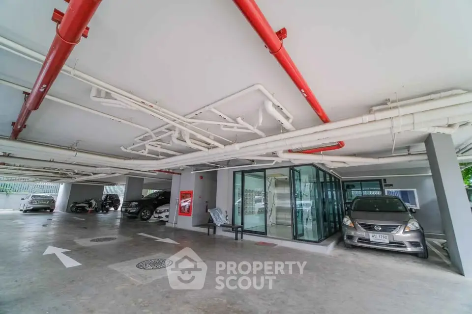 Modern parking area with ample space and secure entry in residential building.