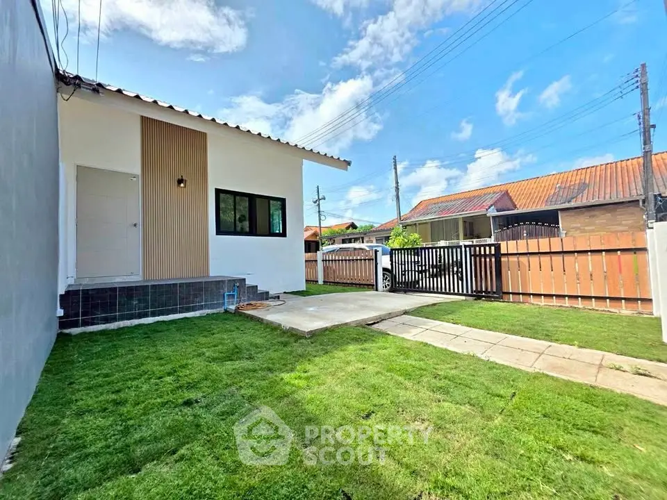Charming single-story home with lush green lawn and modern exterior design, perfect for family living.
