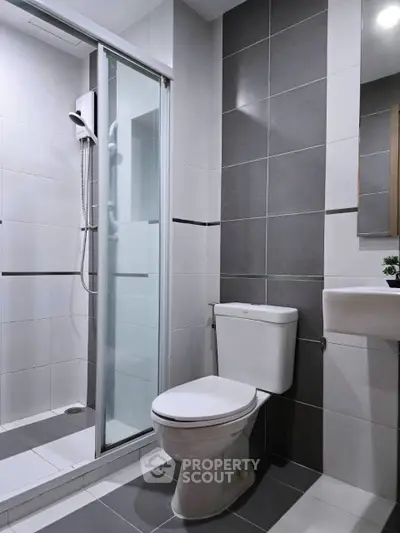 Modern bathroom with sleek shower and contemporary fixtures in stylish apartment.