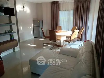 Spacious living room with modern dining area and natural light