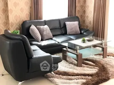 Elegant living room with modern black leather sofa and glass coffee table