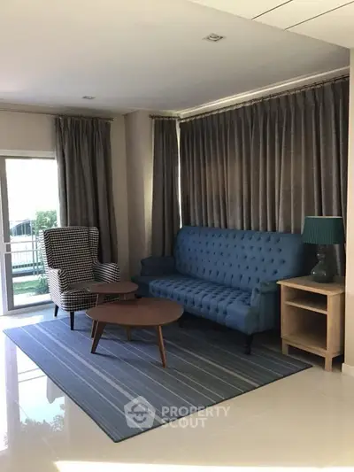 Stylish living room with modern furniture and large windows for natural light.
