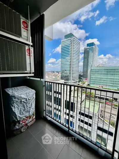 Stunning high-rise balcony view with modern cityscape and clear blue sky.