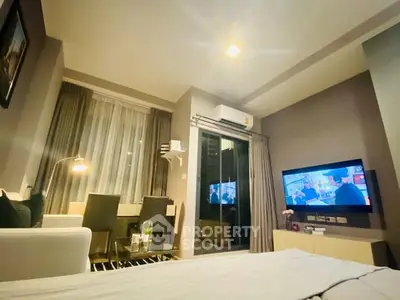 Modern living room with cozy seating and wall-mounted TV in stylish apartment