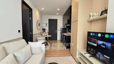 Modern living room with open kitchen layout and stylish decor