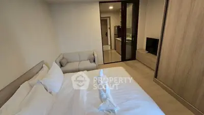 Modern bedroom with cozy bed, stylish wardrobe, and elegant decor in a contemporary apartment.