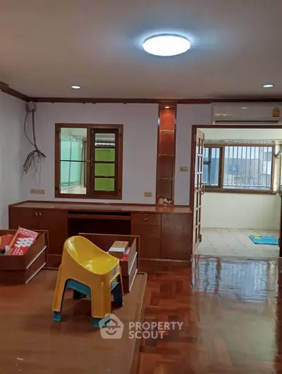 Spacious living room with wooden flooring and natural light