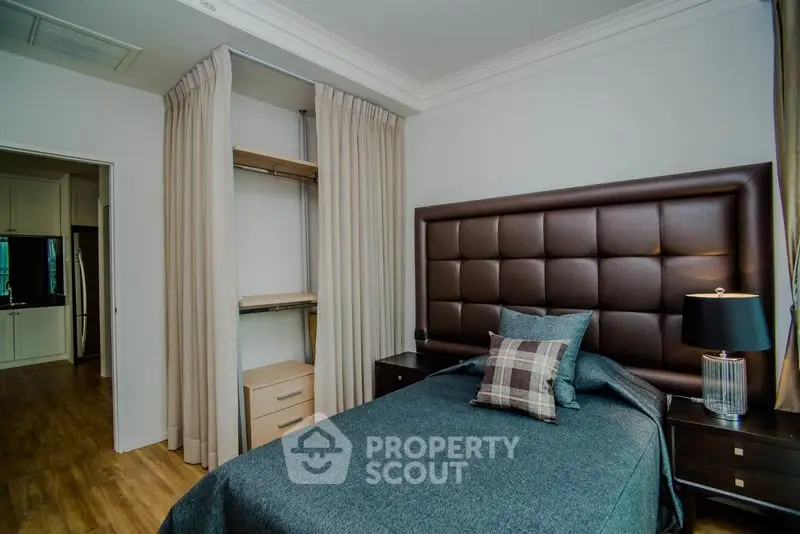 Cozy bedroom with elegant decor and built-in storage in modern apartment.