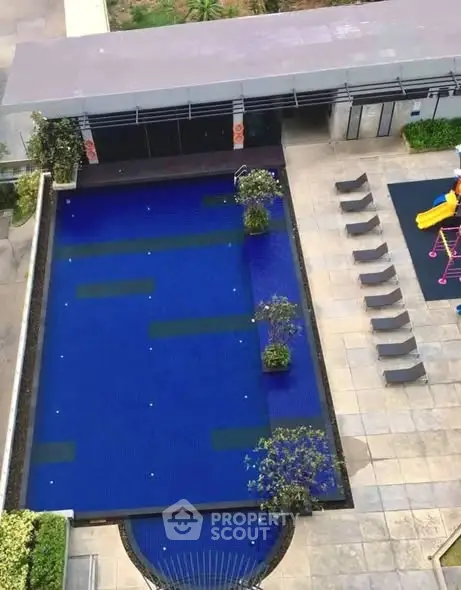 Luxurious rooftop pool with modern lounge area and children's play zone