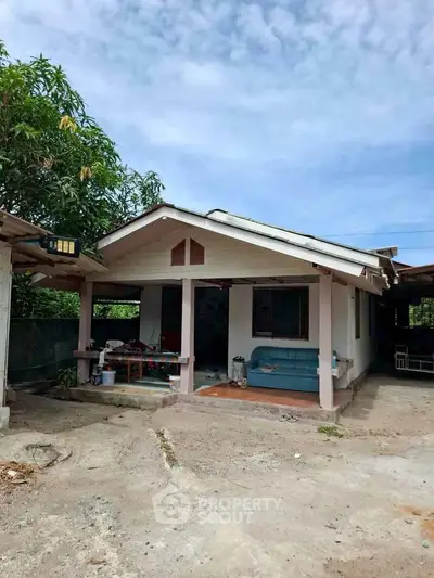 Charming single-story house with spacious front yard and cozy porch, perfect for serene living.