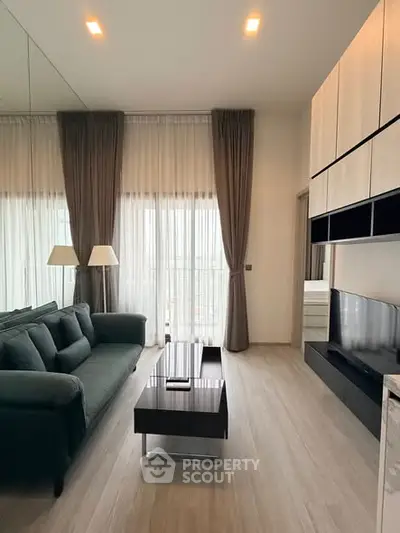 Modern living room with sleek furniture and floor-to-ceiling windows