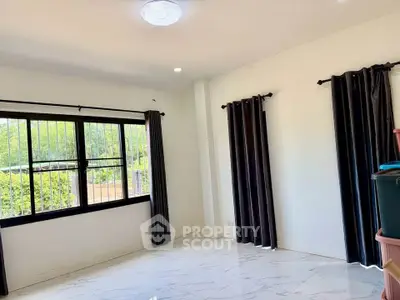 Spacious empty room with large window and elegant curtains, perfect for customization.