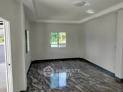 Spacious empty room with glossy marble flooring and large windows
